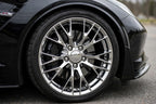Close-up of chrome 10-spoke alloy wheel installed on a black Chevrolet Corvette